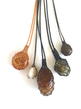 Small beach pebble caged in bronze