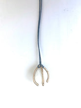 Small beach pebble caged in bronze